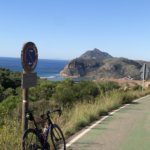 Road cyclists overlooking Portmán Bay on the Murcia Region coastline