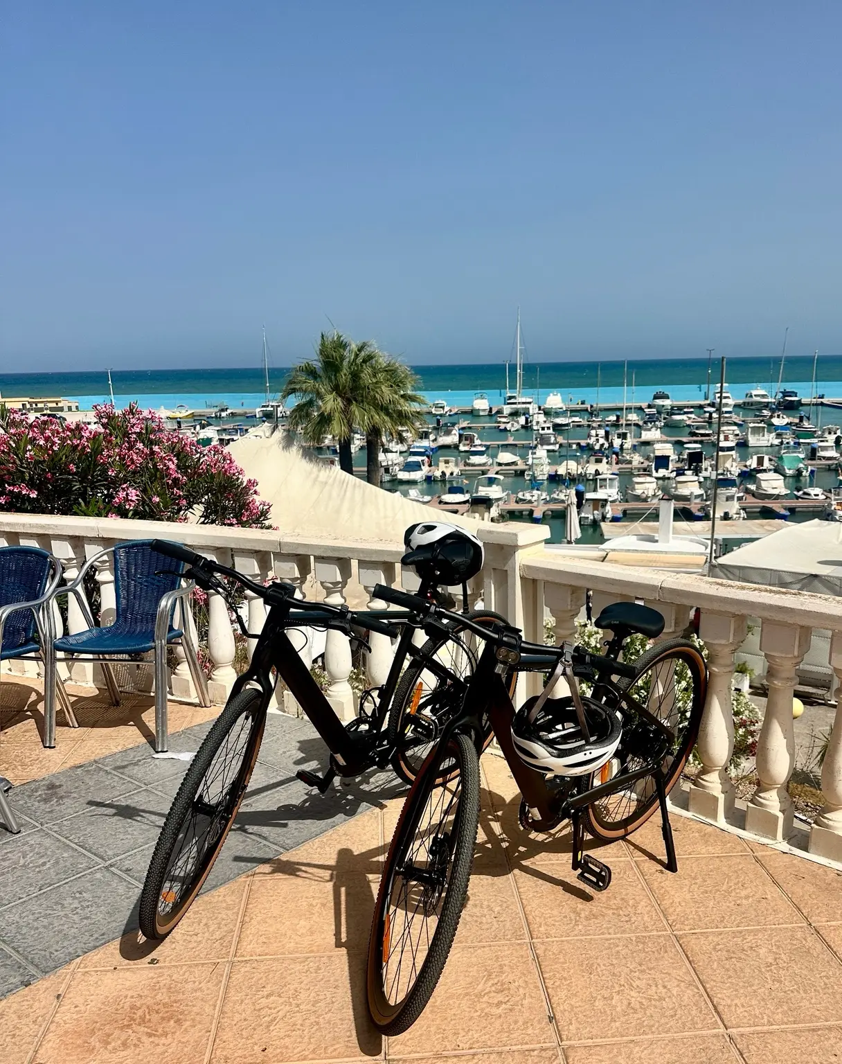 Two Fiido C21 e-bikes overlooking a Mediterranean marina
