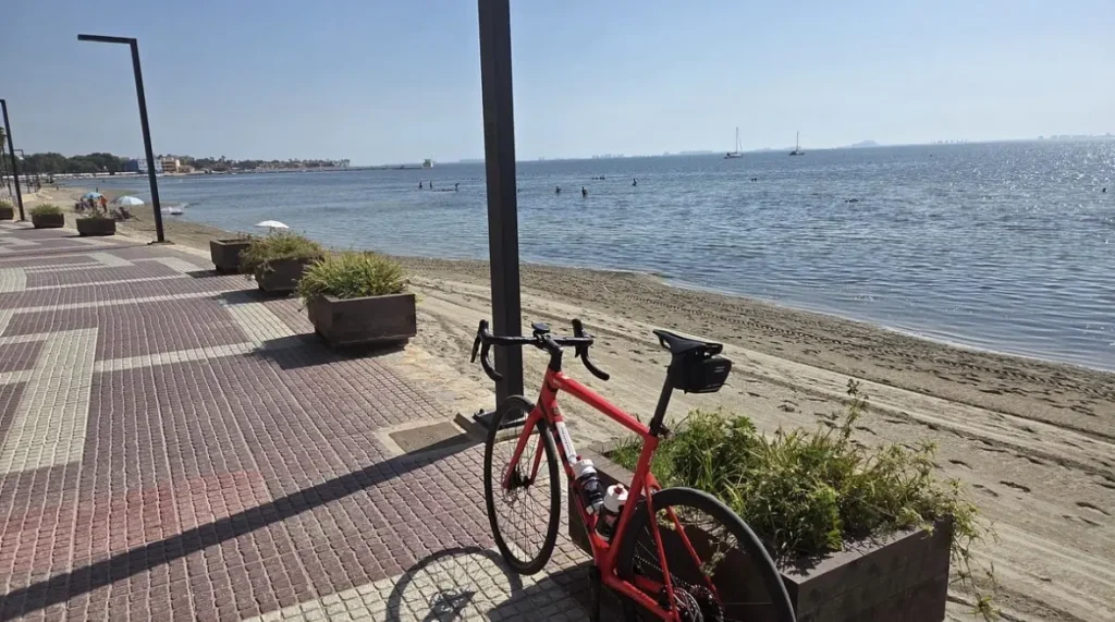 Mick’s red BMC carbon road bike beside the Mar Menor during an OriMar Bikes hire